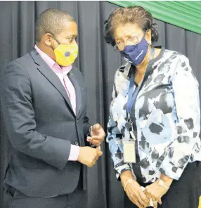  ?? JIS ?? Minister of Agricultur­e and Fisheries Floyd Green (left) engages in discussion with executive advisor at Guardian Life Limited, Fay Hutchinson, during a recent meeting at the Ministry’s Hope Gardens offices in Kingston.