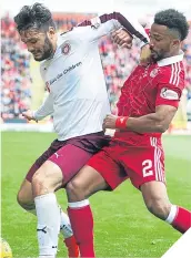  ??  ?? Tony Watt holds off Shay Logan.