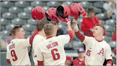  ?? NWA Democrat-Gazette/ANDY SHUPE ?? Arkansas second baseman Casey Martin (right) celebrates with teammates Jax Biggers (from left), Evan Lee and Hunter Wilson after hitting a three-run home run in the second inning of the Razorbacks’ 18-1 victory over Dayton on Wednesday at Baum Stadium...