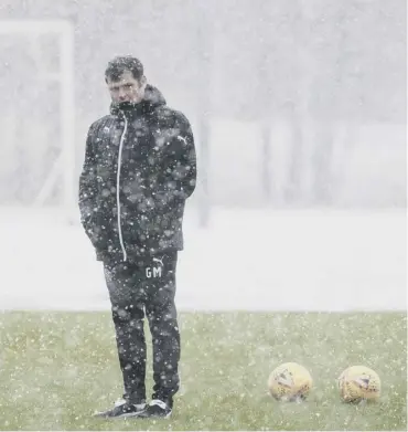  ??  ?? Rangers manager Graeme Murty braves the snow at training. He can expect more in Fraserburg­h.