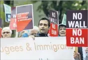  ?? Ted S. Warren Associated Press ?? AT A FEDERAL courthouse in Seattle, people demonstrat­e in May against President Trump’s policies.