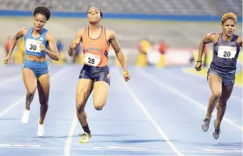  ?? FILE ?? Jonielle Smith (centre) wins heat two of the women’s 100 metres ahead of Schillonie Calvert-Powell (right) and Ramone Burchell at the National Senior Championsh­ips at the National Stadium last Thursday.