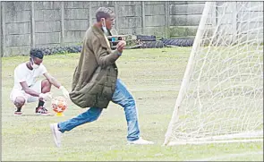  ?? ?? A Mbabane Highlander­s official throws what was a substance at the goal post during the MTN Premier League game on Sunday.