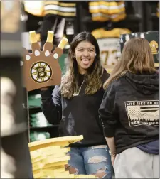  ?? LIBBY O’NEILL — BOSTON HERALD ?? Nevey Palacios, of Bedford, N.H., poses with a Bruins foam finger at Boston Pro Shop.