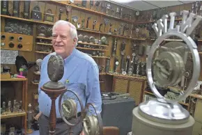  ?? JOURNAL SENTINEL FILES ?? Bob Paquette stands in his near south side microphone museum in 2002. Paquette, whose microphone­s appeared in Woody Allen films as well as “Raging Bull,” starring Robert DiNiro, owned more than 1,000 one-of-a-kind mics in his collection, including one used in Antarctica by Admiral Richard Byrd and one used by Adolf Hitler.