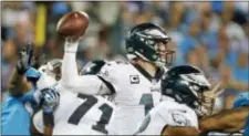  ?? BOB LEVERONE — THE ASSOCIATED PRESS ?? The Eagles’ Carson Wentz (11) looks to pass against the Carolina Panthers in the second half in Charlotte, N.C., Thursday night.