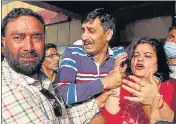  ?? WASEEM ANDRABI/HT ?? Family members of the slain Kashmiri Pandit grieve outside a hospital in Srinagar on Thursday.