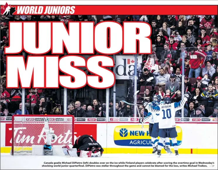  ?? —CP ?? Canada goalie Michael DiPietro (left) doubles over on the ice while Finland players celebrate after scoring the overtime goal in Wednesday’s shocking world junior quarterfin­al. DiPietro was stellar throughout the game and cannot be blamed for the loss, writes Michael Traikos.