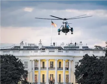  ?? J. SCOTT APPLEWHITE/AP ?? President Trump aboard Marine One returns to the White House on Monday after a stay at a medical military hospital.