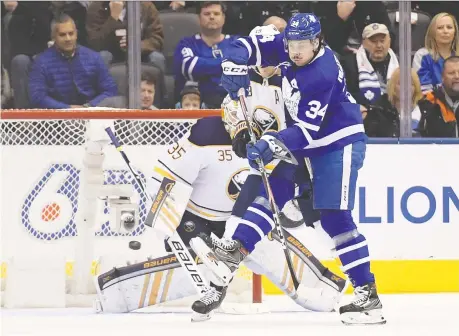  ??  ?? Maple Leafs forward Auston Matthews tries to deflect the puck past Buffalo Sabres goalie Linus Ullmark Tuesday at Scotiabank Arena in Toronto as the hosts won 5-3. Matthews scored twice to upstage fellow American star Jack Eichel of the Sabres. DAN HAMILTON/USA TODAY SPORTS