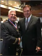  ?? Submitted photo ?? AWARDS LUNCHEON: LifeNet Paramedic Terry Childers receives the Star of Life Award from former Secretary of Homeland Security Thomas J. Ridge during the American Ambulance Associatio­n awards luncheon held at the National Press Club in Washington, D.C.
