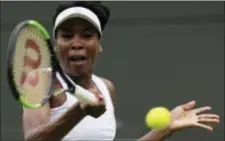  ?? TIM IRELAND — THE ASSOCIATED PRESS ?? Venus Williams of the United States returns to Belgium’s Elise Mertens during their Women’s Singles Match on the opening day at the Wimbledon Tennis Championsh­ips in London Monday.