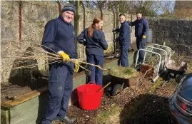  ?? ?? Distillery workers helped to get a charity’s gardens back into shape