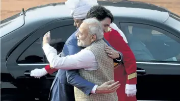  ?? SEAN KILPATRICK/ THE CANADIAN PRESS ?? Prime Minister Justin Trudeau is greeted by Indain Prime Minister Narendra Modi as he arrives for an official welcoming ceremony at the Presidenti­al Palace in New Delhi, India, on Friday.