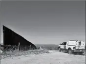  ?? ASSOCIATED PRESS FILE PHOTO ?? A CUSTOMS AND BORDER PROTECTION AGENT monitors where the fence ends along the internatio­nal border April 10 near Nogales, Ariz.