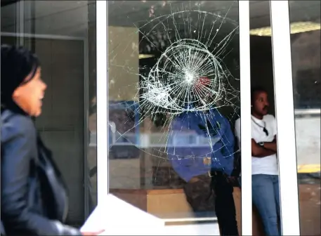  ?? Picture: Ayanda Ndamane / ANA ?? SMASHED: A glass door was damaged after police fired rubber bullets at protesting CPUT students yesterday.