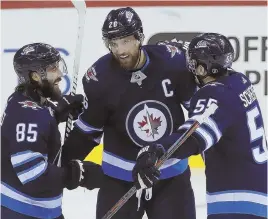  ?? AP PHOTO ?? FRONT AND CENTER: Former Bruins forward Blake Wheeler (center) has become one of the leading men in Winnipeg.