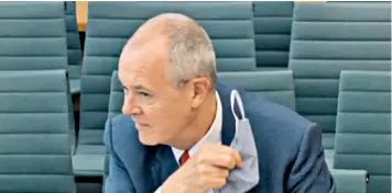  ??  ?? Sir Patrick Vallance removes his mask as he responds to questions from MPS on the Commons science committee