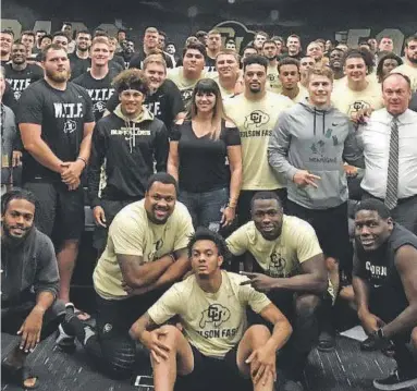  ?? Provided by CU athletic department ?? Rape survivor and social activist Brenda Tracy, center, visits with the CU football team, coaches, staffers and administra­tors in Boulder. She was there to recount the worst night of her life.