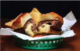  ?? TERRENCE ANTONIO JAMES — CHICAGO TRIBUNE — TNS ?? The “Juicy Lucy’s” cheeseburg­er, stuffed with giardinier­a and chihuahua cheese, is served up at The Junction Diner in Forest Park, Illinois.