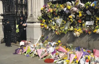  ?? Matt Dunham / Associated Press ?? Flowers form a memorial to the victims a terrorist attack near Parliament in London last week.