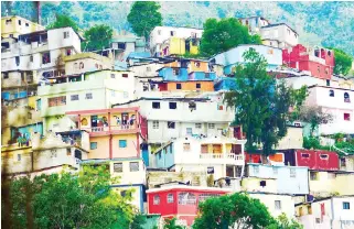  ?? HEATHER SUGGITT -UNSPLASH ?? HOUSES built on the mountains just outside of Port-au-Prince.