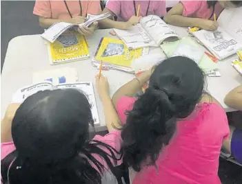  ?? U.S. DEPARTMENT OF HEALTH AND HUMAN SERVICES/HANDOUT ?? Children attend classes and watch movies in warehouse-sized, air-conditione­d white tents. “We provide all of them with the services that are required and we treat them with care,” program director Leslie Wood said.