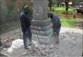  ?? PHOTOS BY THE ASSOCIATED PRESS ?? Workers begin removing a Confederat­e statue in Gainesivll­e, Fla., Monday, Aug. 14, 2017. The statue is being returned to the local chapter of the United Daughters of the Confederac­y, which erected the bronze statue in 1904. County officials said they...