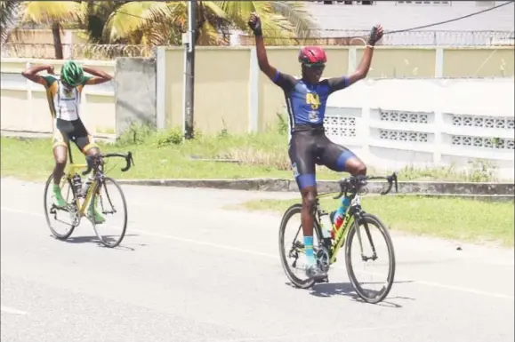  ??  ?? Romello Crawford celebrates after crossing the finish line ahead of breakaway mate, Curtis Dey yesterday.