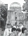  ?? JOHANNES EISELE, AFP/GETTY IMAGES ?? Visitors at the Hiroshima Peace Memorial in Japan.
