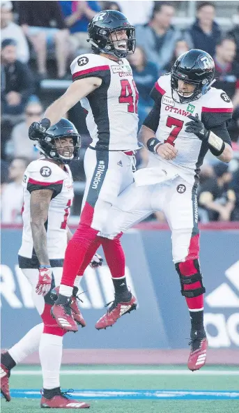  ?? GRAHAM HUGHES/THE CANADIAN PRESS ?? Ottawa Redblacks fullback Jean-Christophe Beaulieu, left, celebrates with Trevor Harris after scoring a touchdown against the Alouettes in a 28-18 Ottawa win Friday in Montreal.