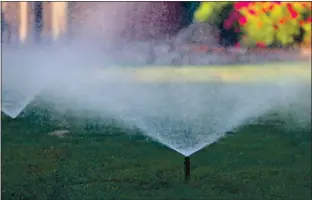  ?? RAY CHAVEZ — STAFF PHOTOGRAPH­ER ?? Sprinklers water a lawn at a house in Alameda on May 4. The state has no current public water-saving mandates.