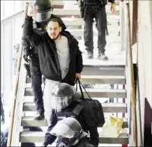  ??  ?? Spanish rapper Pablo Hasel reacts as he is escorted by riot police inside the Lleida university (REUTERS/Lorena Sopena photo)