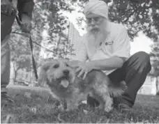  ?? KEITH BEATY/TORONTO STAR ?? Yogi Akal blesses Riel, a Portuguese-terrier mix, during an event staged by St. John Ambulance’s Therapy Dog Services at Allan Gardens.
