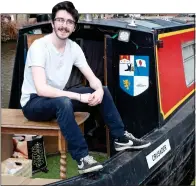  ??  ?? FUN AFLOAT: Toby Spiller on his 49ft barge, Crusader