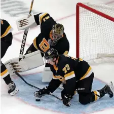  ?? STUART CAHILL / HERALD STAFF FILE ?? ‘CALMING PRESENCE’: Bruins defenseman Charlie McAvoy gives goaltender Jaroslav Halak a hand in the crease last month against the Oilers.