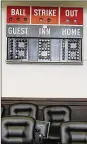  ?? KAREN SCHIELY / AKRON BEACON JOURNAL ?? Summit County Judge Amy Corrigall Jones bought this antique scoreboard — with her own money — as part of a new probation program she’s overseeing called SCORR (Summit County Offender Recidivism Reduction).