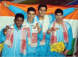  ?? — PTI ?? The gold- medal winning team of Sajan Prakash ( from left), Neil Contractor, Saurabh Sangvekar and Raj Bhanwadia pose after the men’s 4x200m freestyle swimming race in Guwahati on Tuesday.