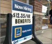  ?? ELISE AMENDOLA — THE ASSOCIATED PRESS FILE ?? A sign outside a business in Salem, N.H. says “Now Hiring.”