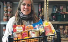  ?? ?? Hope Kitchen’s services manager Catriona Petit with tinned and canned food that can be heated quickly.