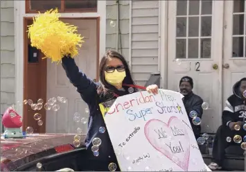  ?? Lori Van Buren / Times Union ?? Teachers from Sheridan Preparator­y Academy in Albany, including Ms. Cheuk, seen here, ride in a parade in April to show how much they miss their students.