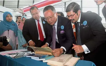  ?? — Bernama ?? Historical data: Abdul Rahman (centre) looking at reports and books from the Population and Housing Census 1957 after the launch of MyStats Day 2017 at Pusat Permata Pintar Negara in Universiti Kebangsaan Malaysia, Bangi. Looking on is Chief...