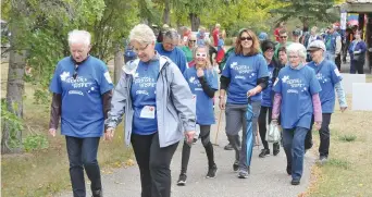  ??  ?? Walkers take to the course around Wakamow Valley at the start of the Parkinson’s SuperWalk.