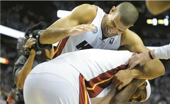  ?? MICHAEL LAUGHLIN/SOUTH FLORIDA SUN SENTINEL ?? Shane Battier jokes with teammate LeBron James after the Heat beat the Bulls in Game 5 of the Eastern Conference semifinals in 2013.