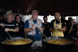  ?? ERIC ROJAS — THE NEW YORK TIMES, FILE ?? Jose Andres, center, the Spanish chef who founded World Central Kitchen, is joined by local chefs in preparing meals for people displaced by Hurrican Maria in San Juan, Puerto Rico, in 2017. Long before the killings of seven workers in Gaza, World Central Kitchen pioneered a new way to deliver emergency relief, using local labor and recipes.