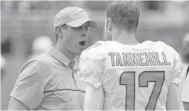  ?? JIM RASSOL/STAFF FILE PHOTO ?? “He looks good to me,” head coach Adam Gase, left, says of quarterbac­k Ryan Tannehill, who missed last season with an injury.