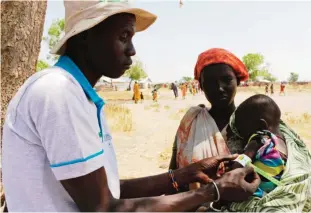  ??  ?? THONYOR: Photo shows a baby getting a Mid-Upper Arm Circumfere­nce (MUAC) test for malnutriti­on. South Sudan, the world’s youngest nation formed after splitting from the north in 2011 has declared famine in some regions, saying 100,000 people faced...