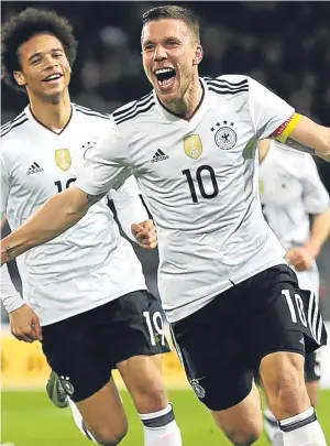  ?? Getty. ?? Lukas Podolski celebrates his winning goal; below left, England manager Gareth Southgate; right: Adam Lallana battles with Toni Kroos.