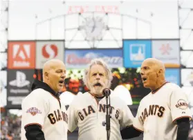  ?? Marcio Jose Sanchez / Associated Press 2013 ?? Bob Weir (center) sings the national anthem with brothers Tom (left) and Tim Flannery, the Giants’ thirdbase coach, before a game at AT&T Park in 2013.