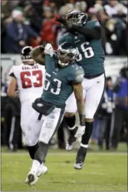  ?? CHRIS SZAGOLA - AP ?? The Philadelph­ia Eagles’ Nigel Bradham (53) and Derek Barnett (96) celebrate during the second half Saturday against the Atlanta Falcons.